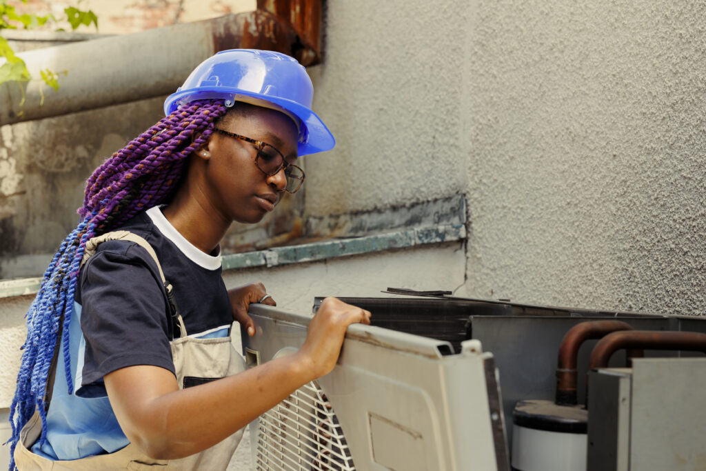 Expert taking apart rusty condenser